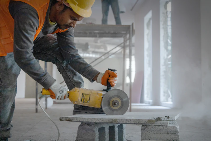 Tradesman working on a concrete floor surface