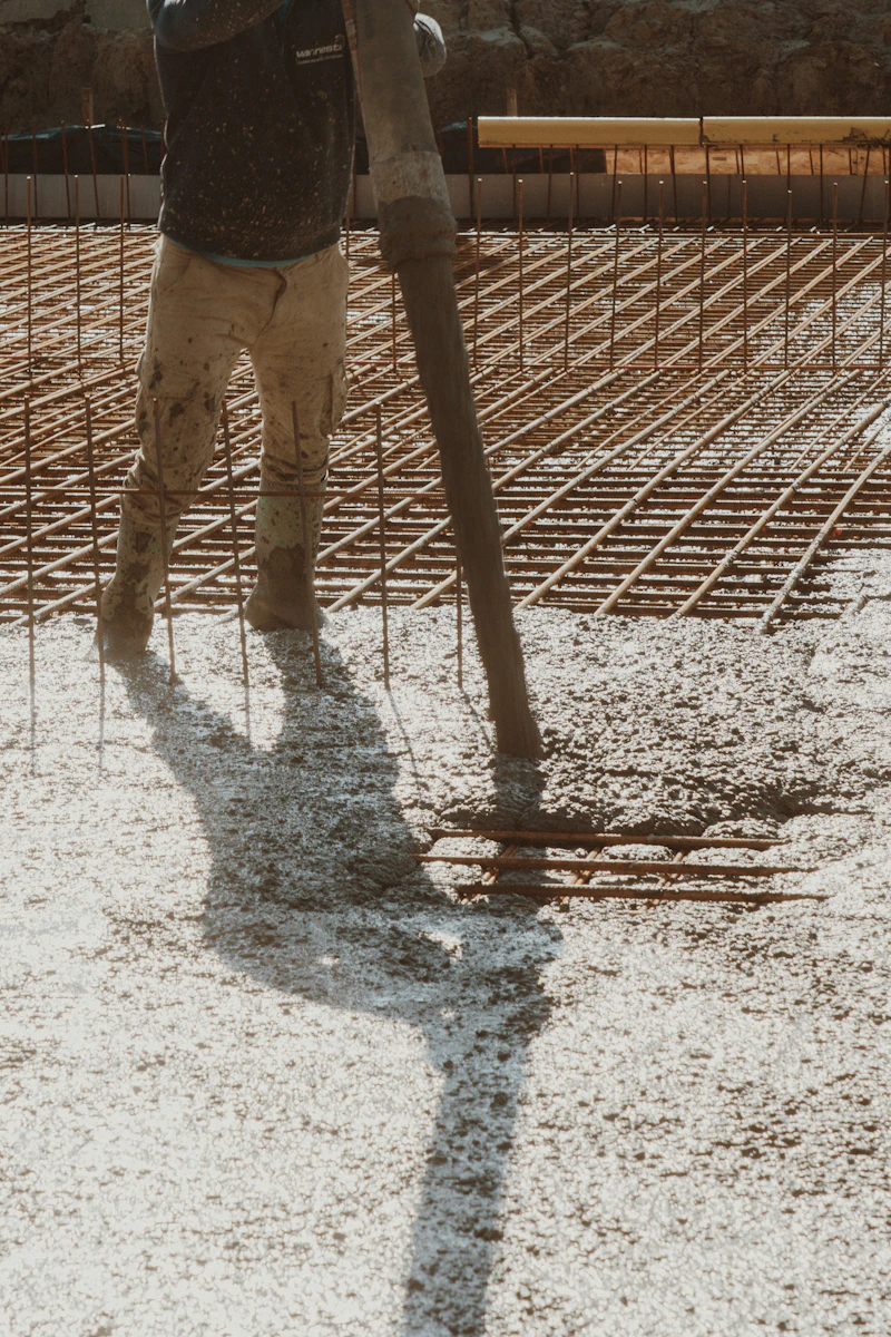 Freshly laid concrete slab being finished by hand