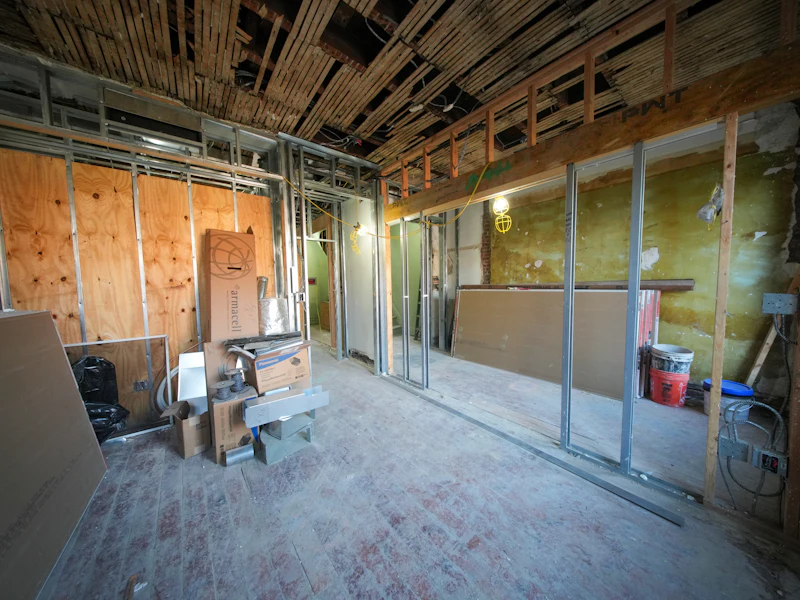 Interior under construction with exposed framing and ceiling
